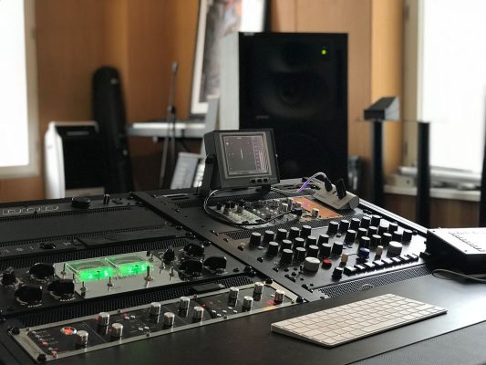 Detail of the analogue processing chain integrated into the black V3 Acoustic 52RU Desk at Blackhead Studios.