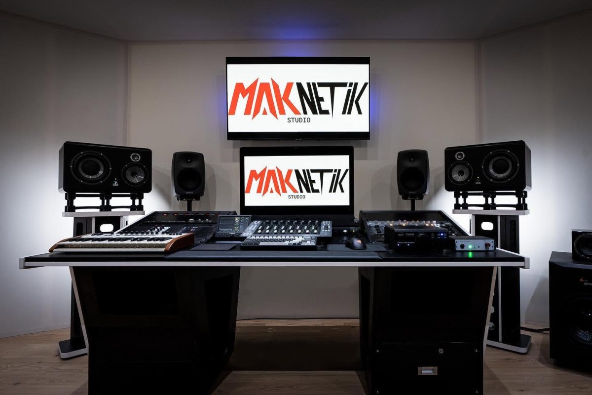 Front view of Maknetik Studio with a white V3 Acoustic 56RU Desk, two V3 Acoustic Stands and integrated production equipment.